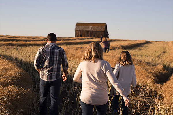 3 people walking in field